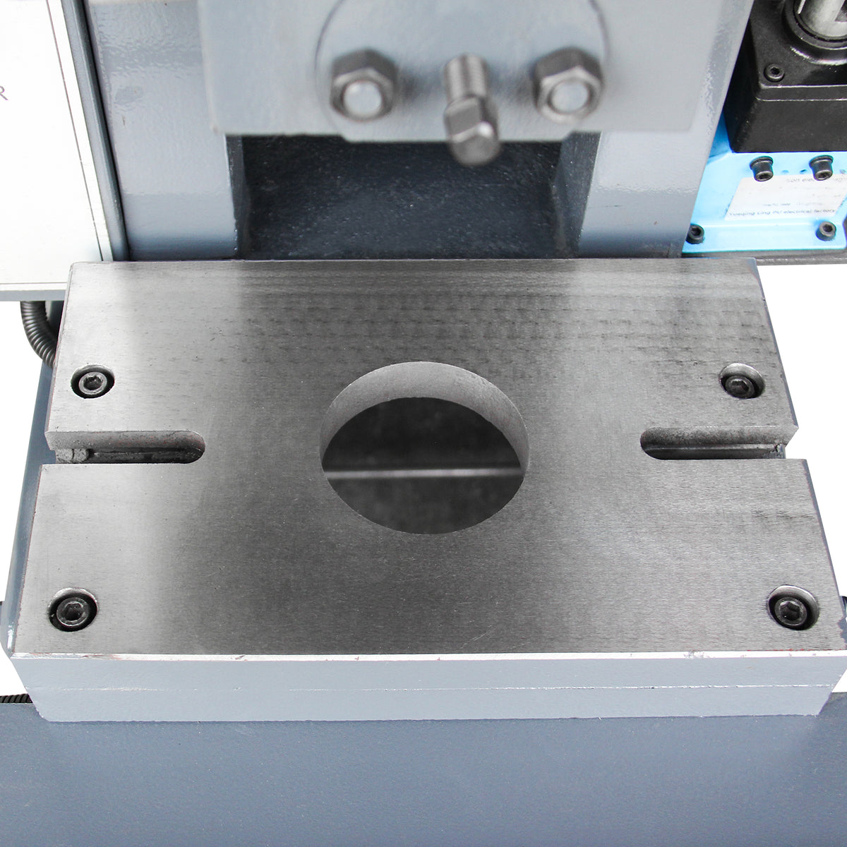 Close-up of the metal punch press worktable and slide block with a large center hole for die set mounting, model JB23-10