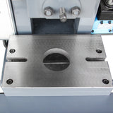 Close-up of the metal punch press worktable and slide block with a large center hole for die set mounting, model JB23-10