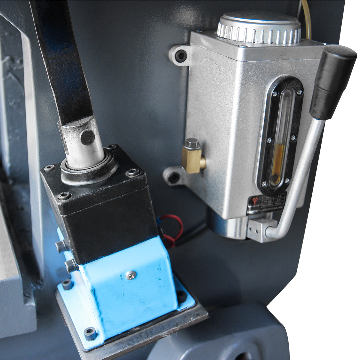 Close-up of the mechanical punch press oil lubricator and blue solenoid valve mechanism for continuous lubrication, model JB23-10